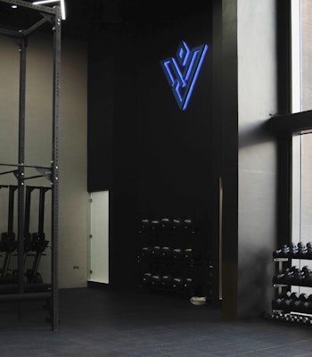 The Vault Fitness Modern gym with dumbbell racks and a fitness studio with branding