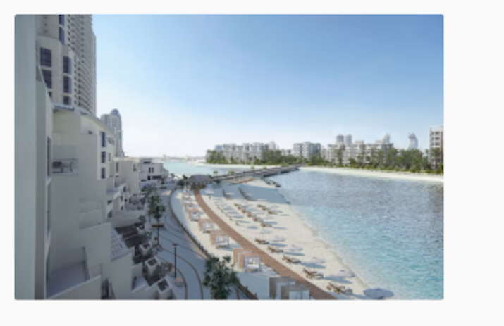 Hilton Doha The Pearl Beachfront resort with lounge chairs and a scenic walkway along the water.