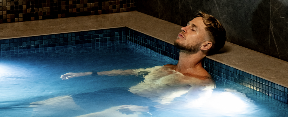 Man floating in spa pool