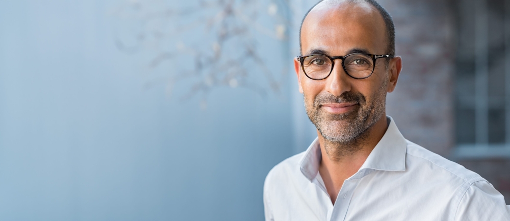 man with a salt and pepper beard wearing glasses