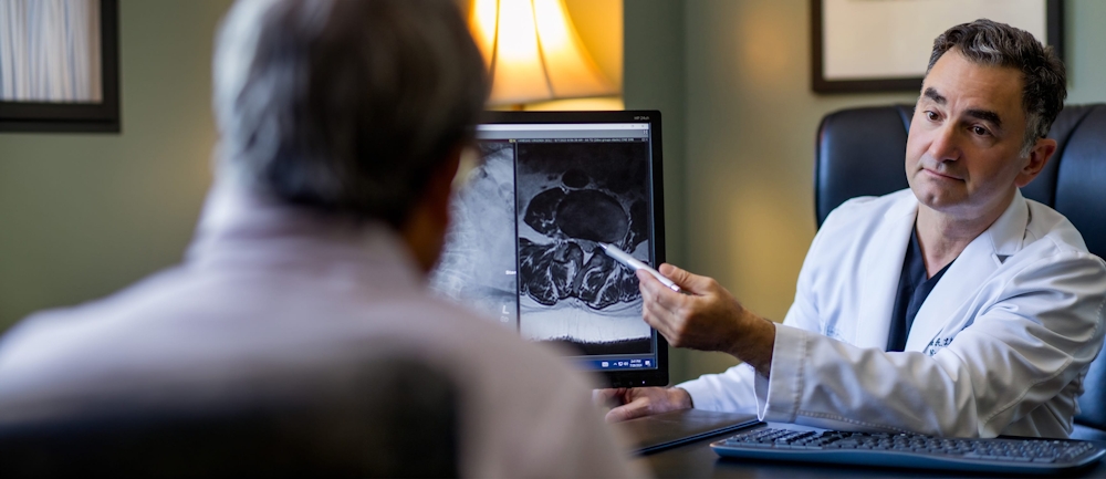 doctor showing a patient information on a computer screen