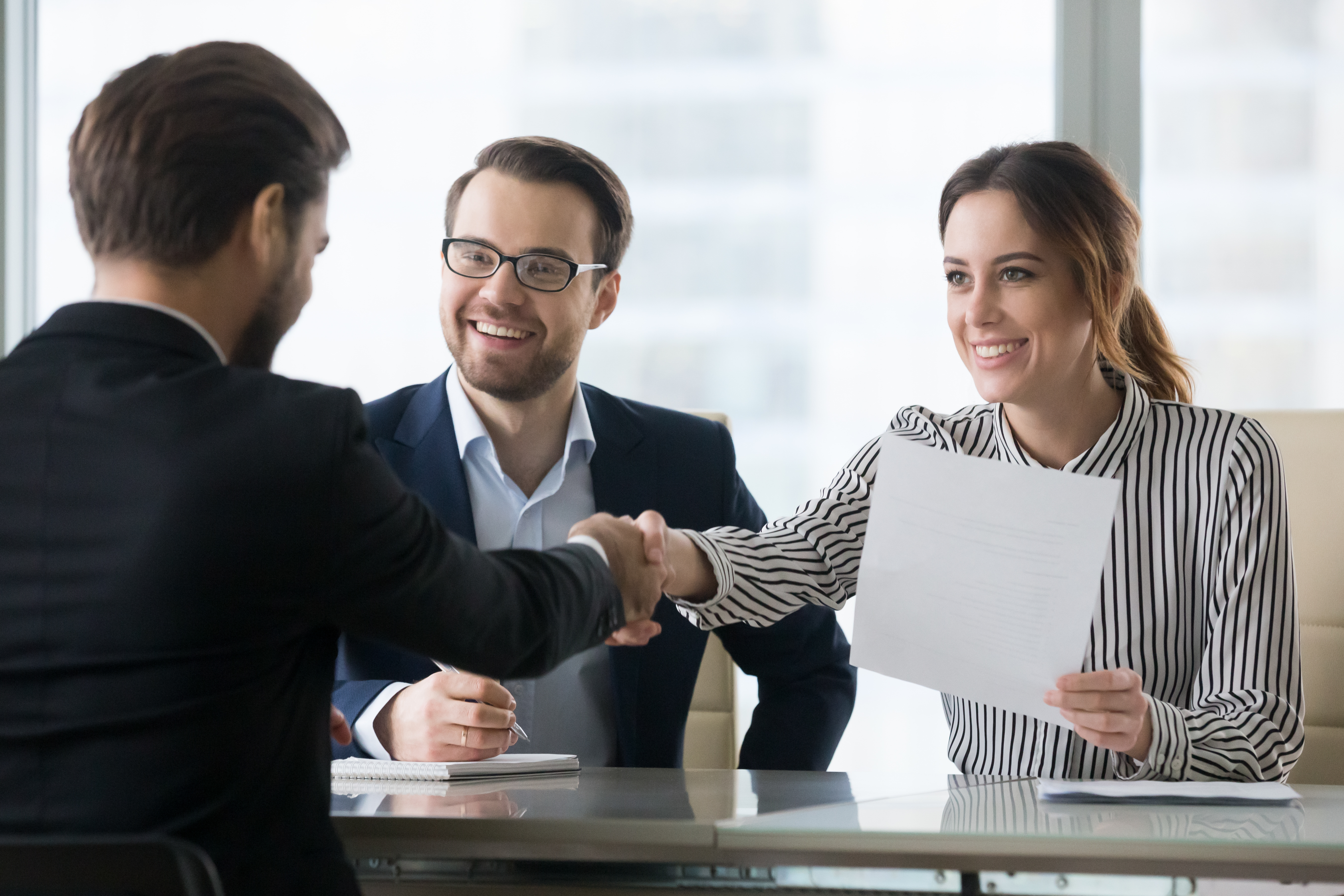 2 men and a woman closing a deal
