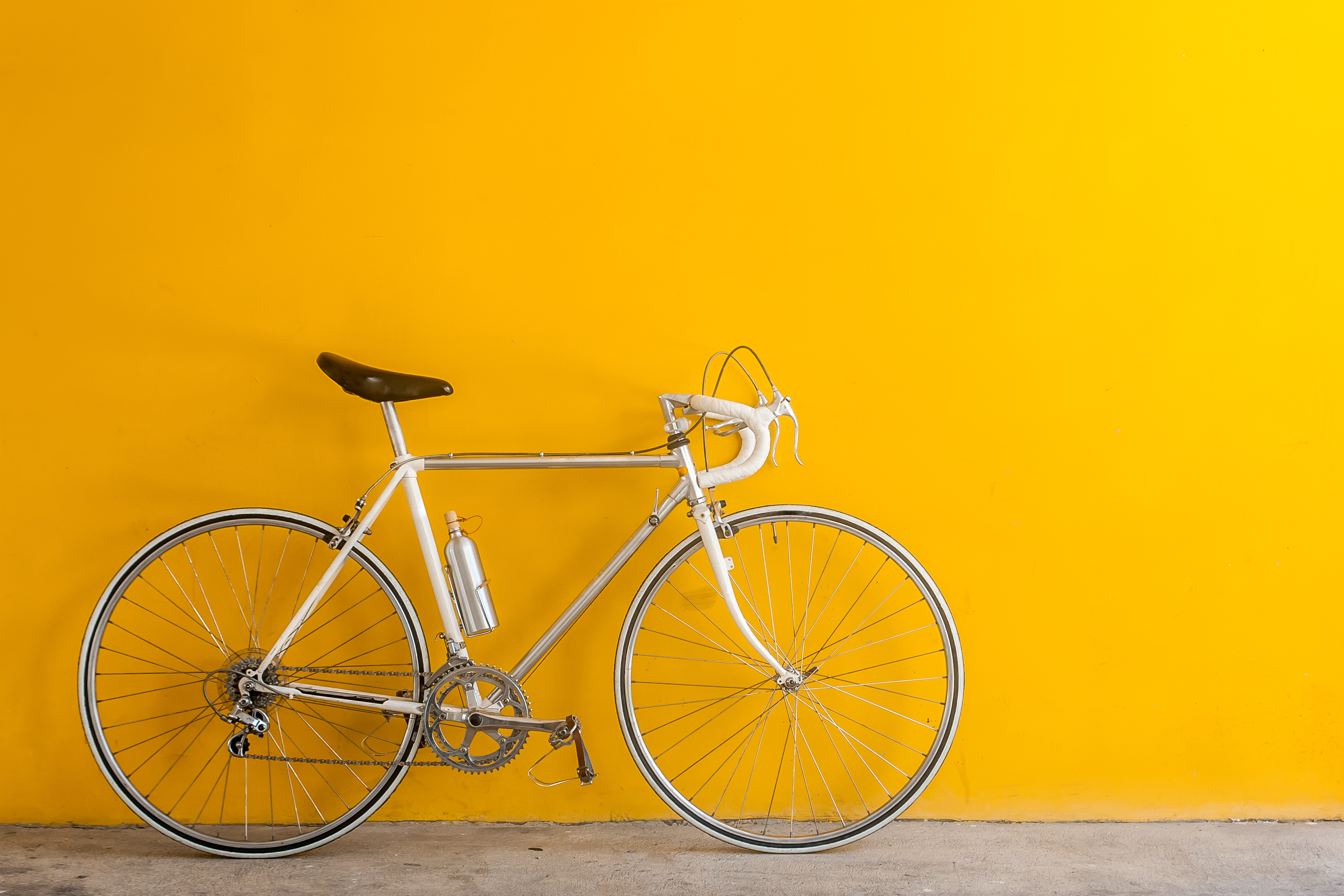 A bike in front of a yellow wall
