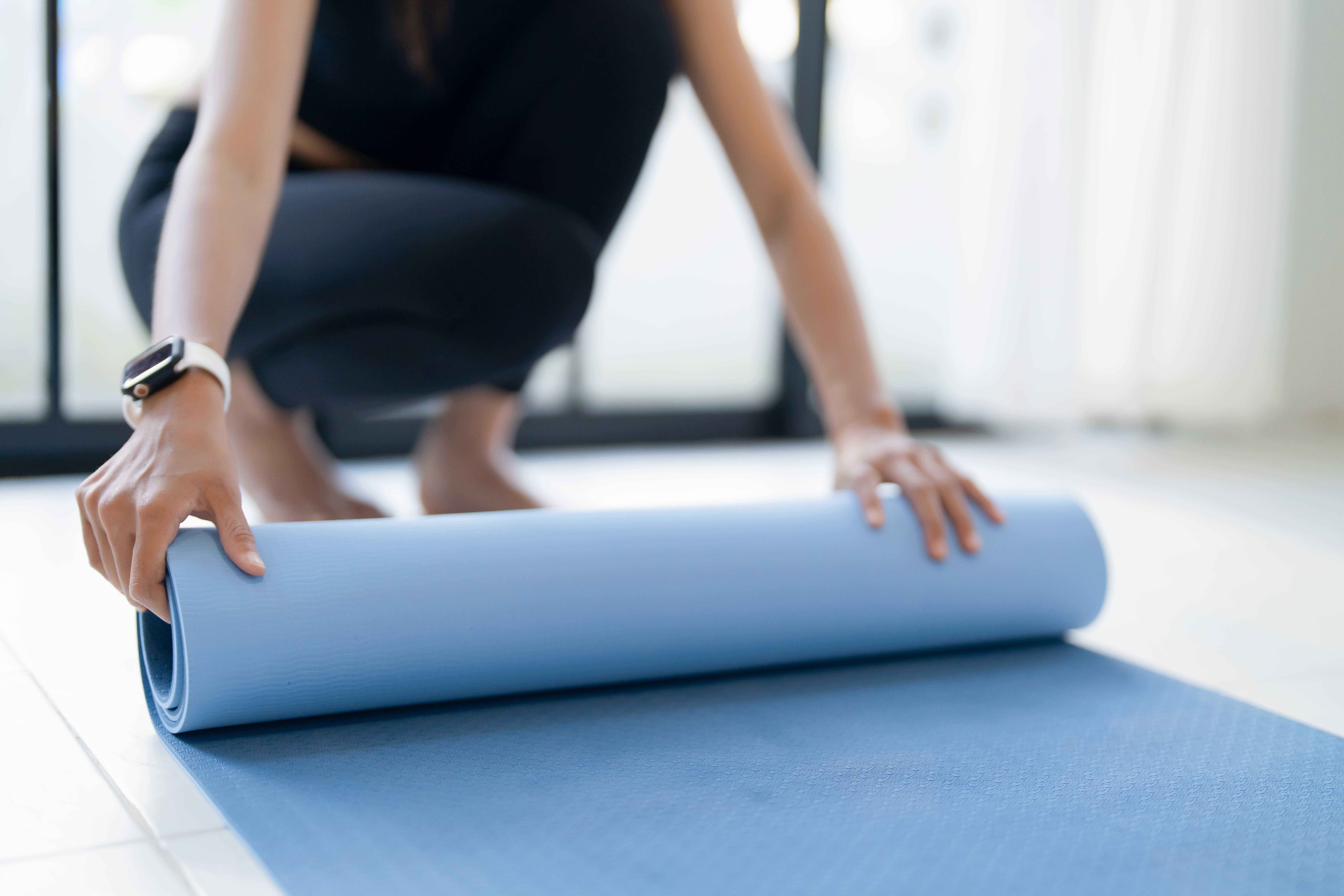 A woman with a yoga mat