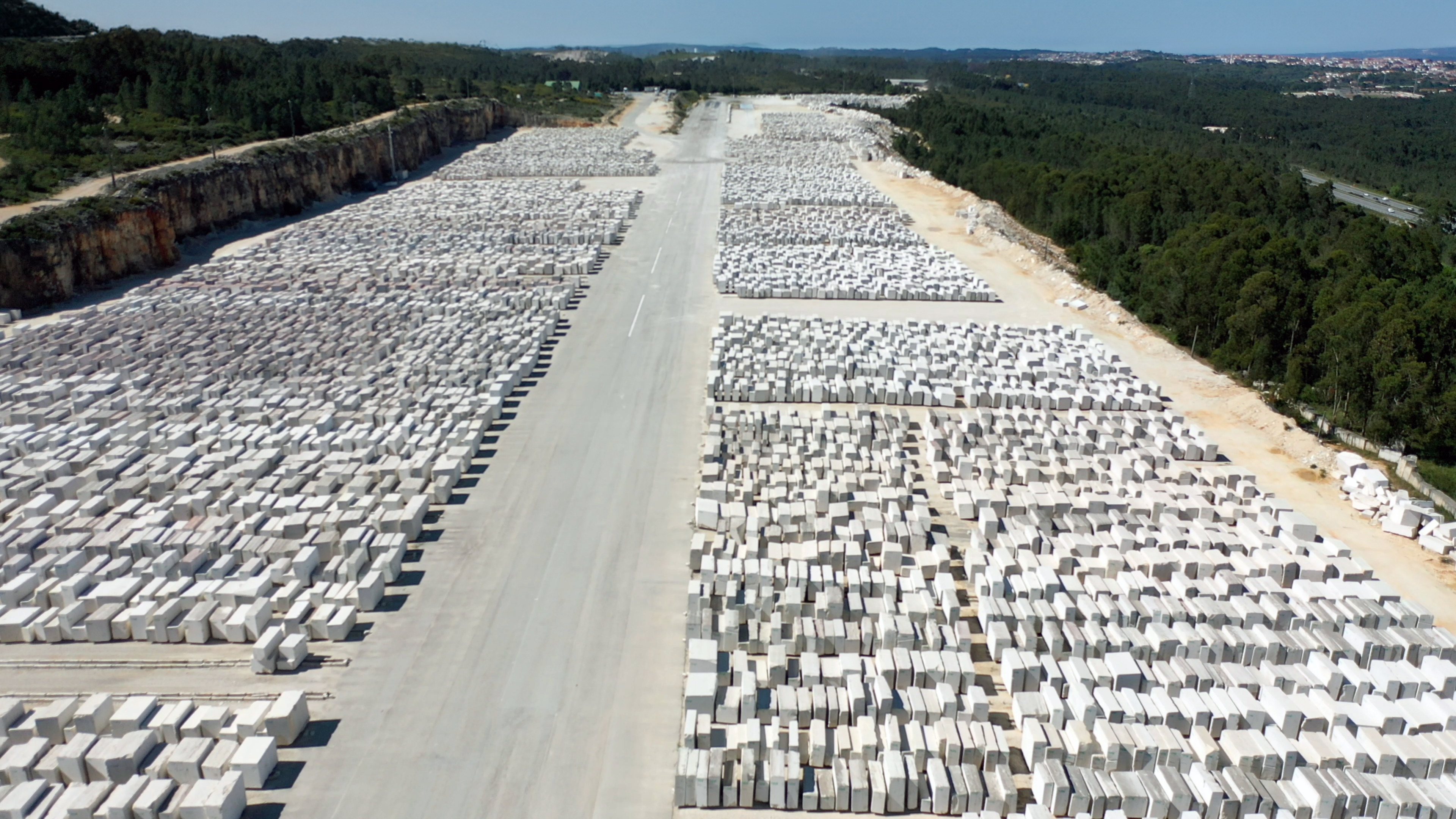 Aerial view of Filstone’s limestone quarry, showcasing hundreds of precisely stacked limestone blocks.