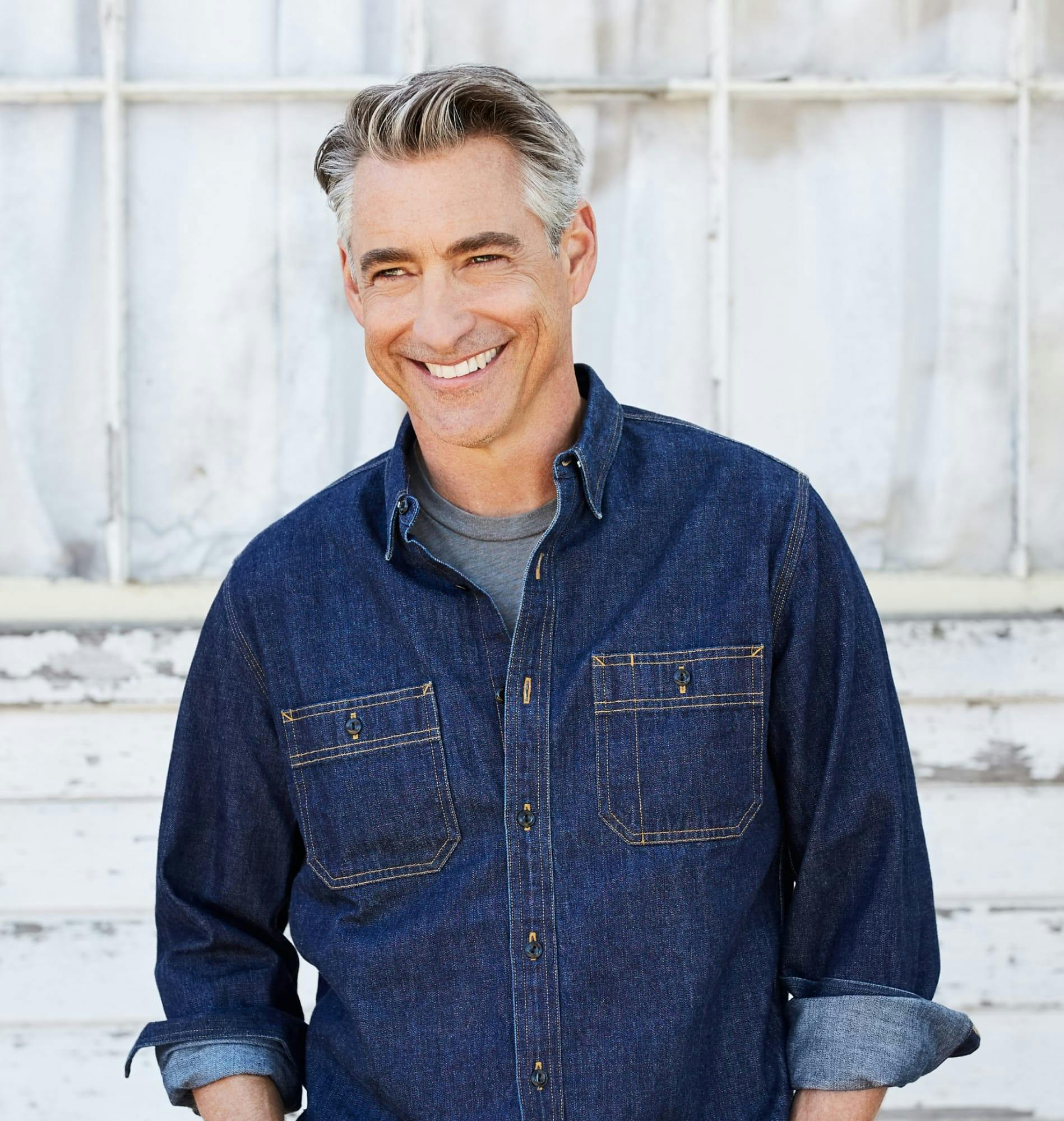 Man with gray hair and a denim jacket