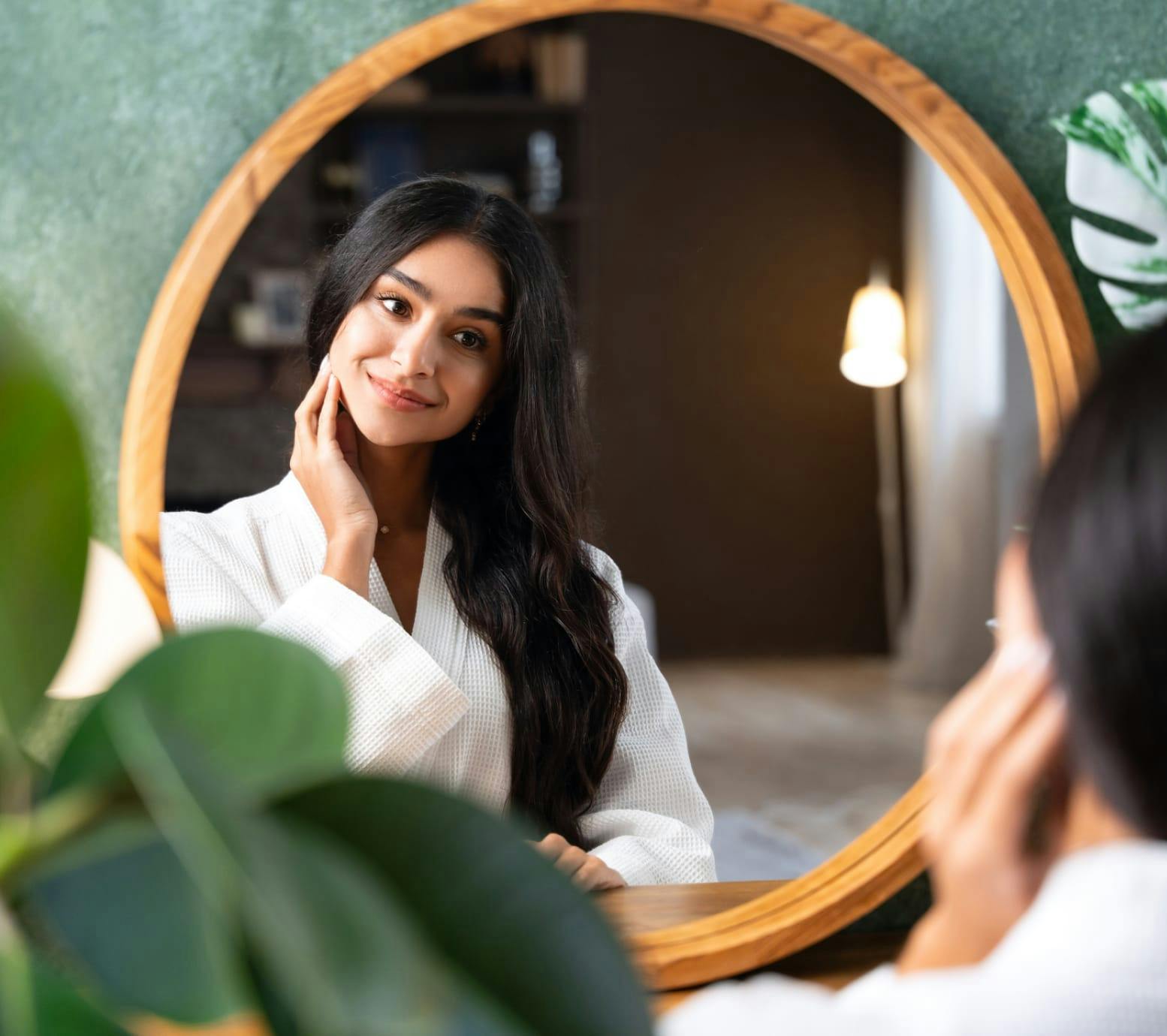 Woman looking at herself in the mirror