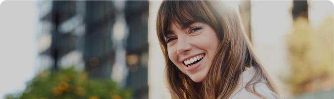 Image of a woman smiling with a blurry background