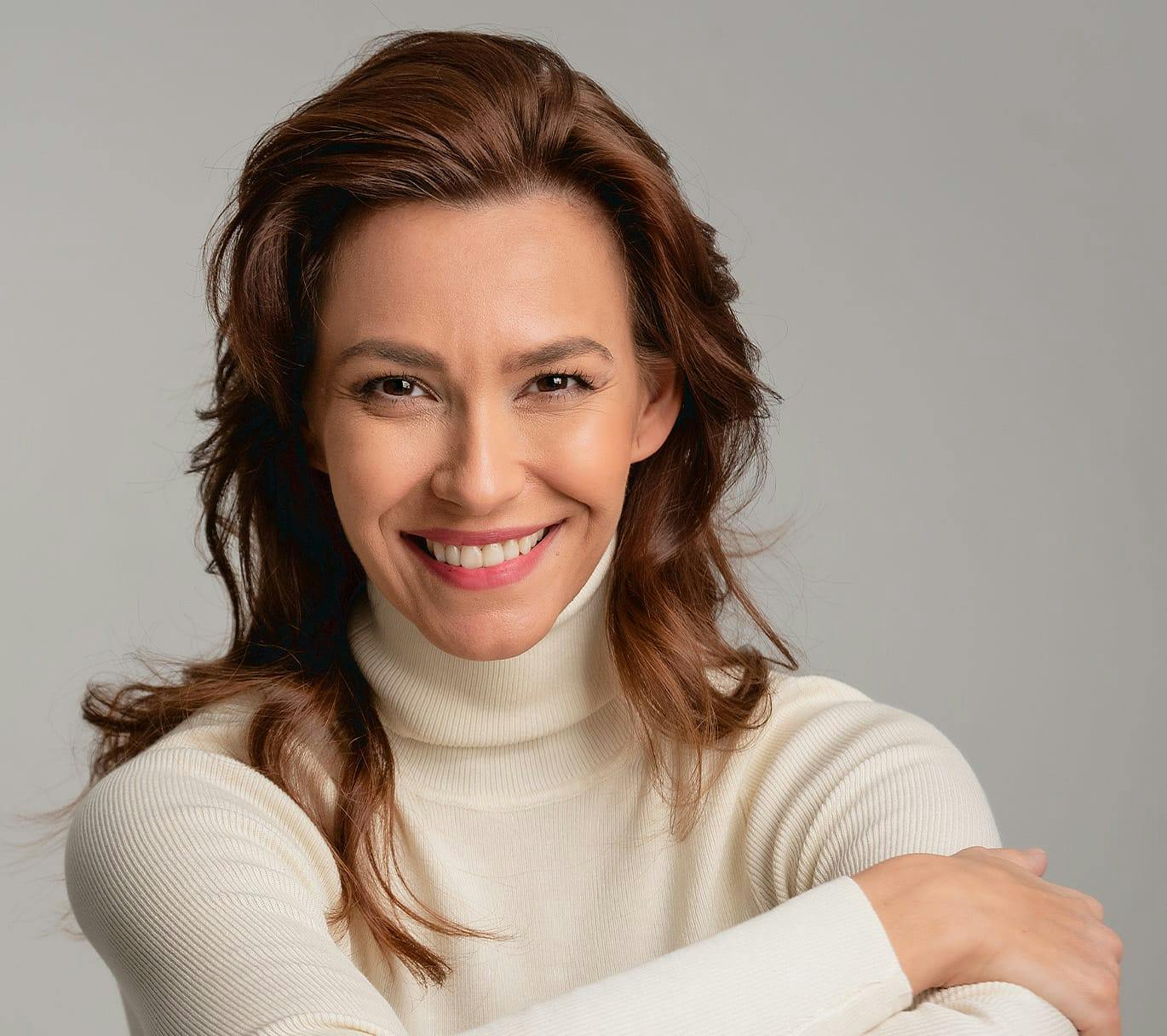 woman smiling in turtleneck