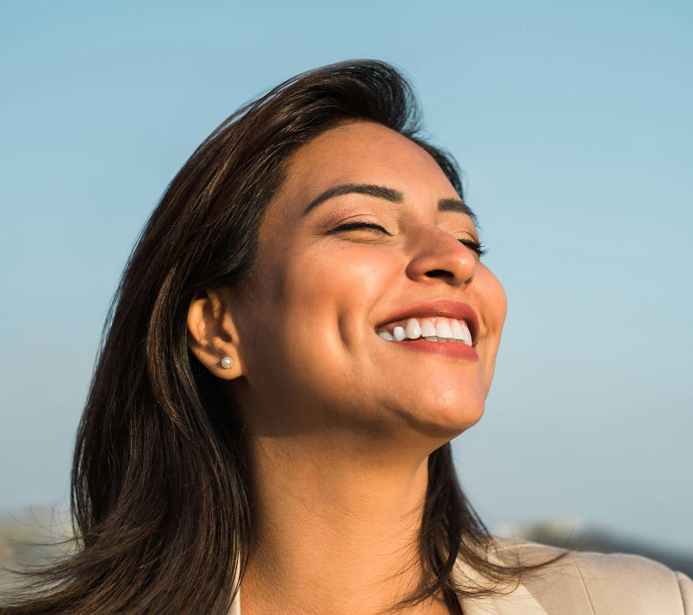 woman smiling with eyes closed