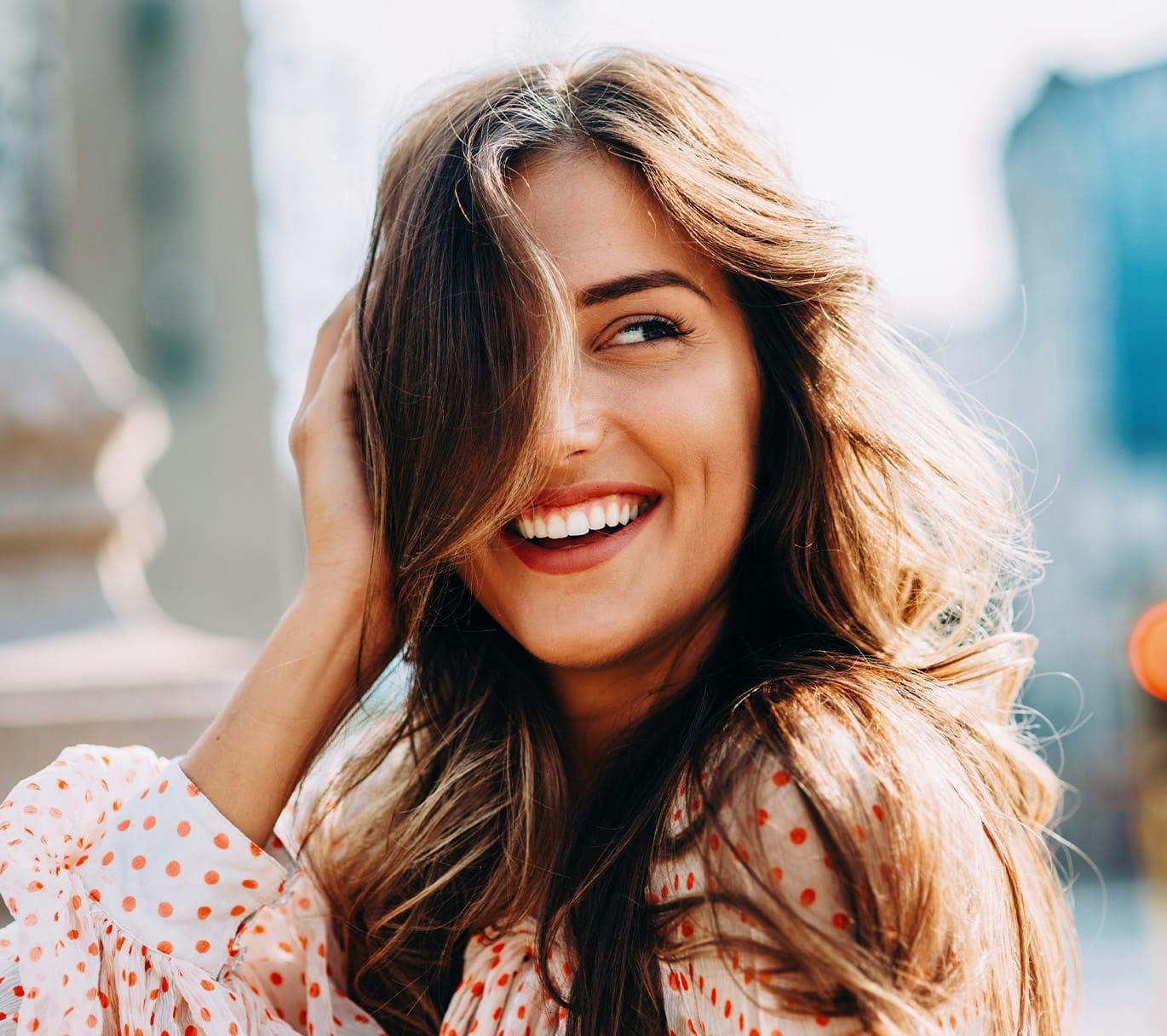 woman smiling with hair in face