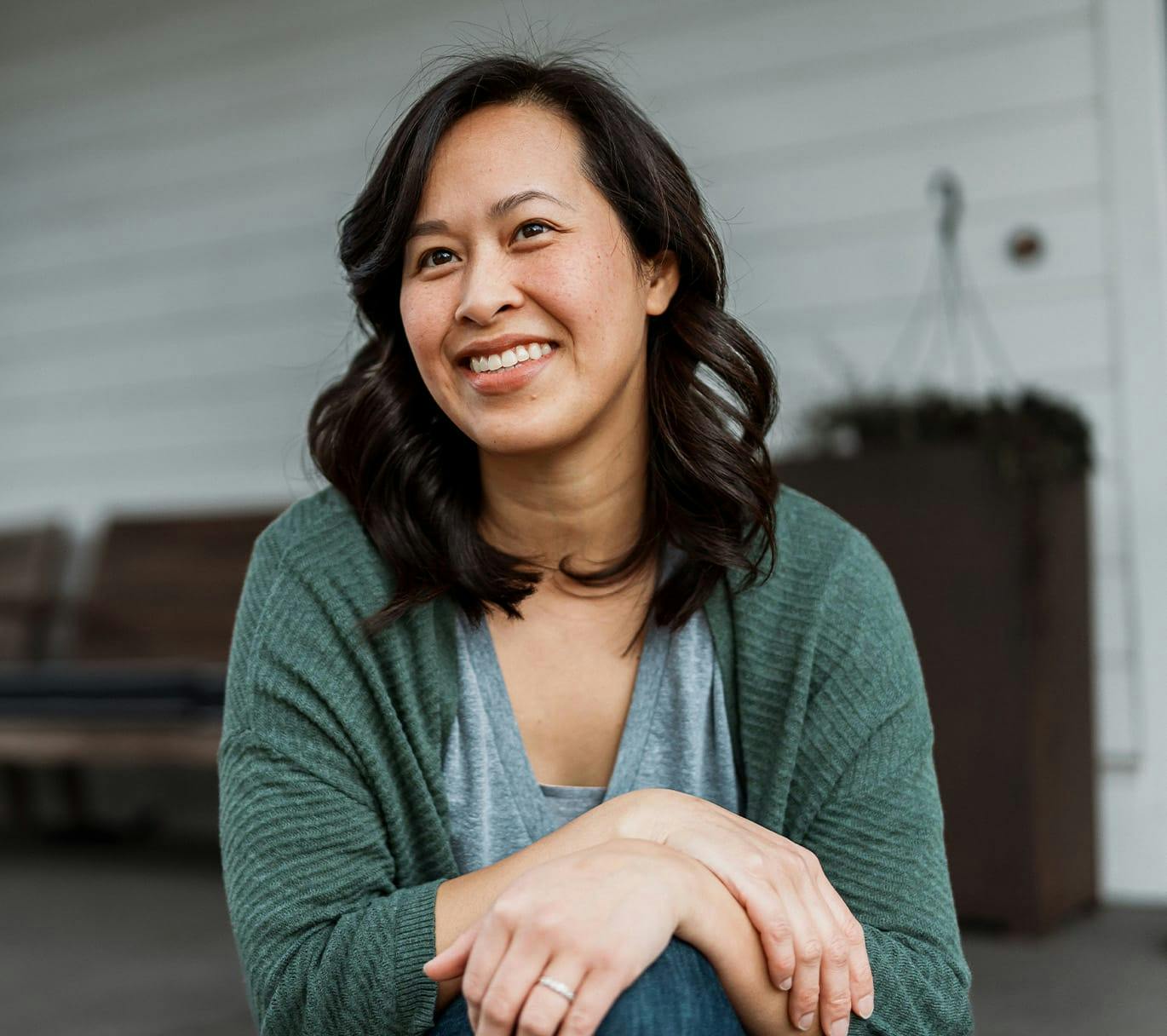 woman smiling with hands on knee