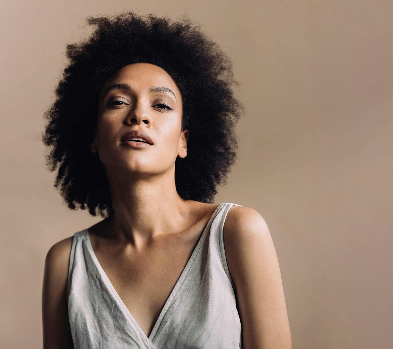 woman standing infront of beige background