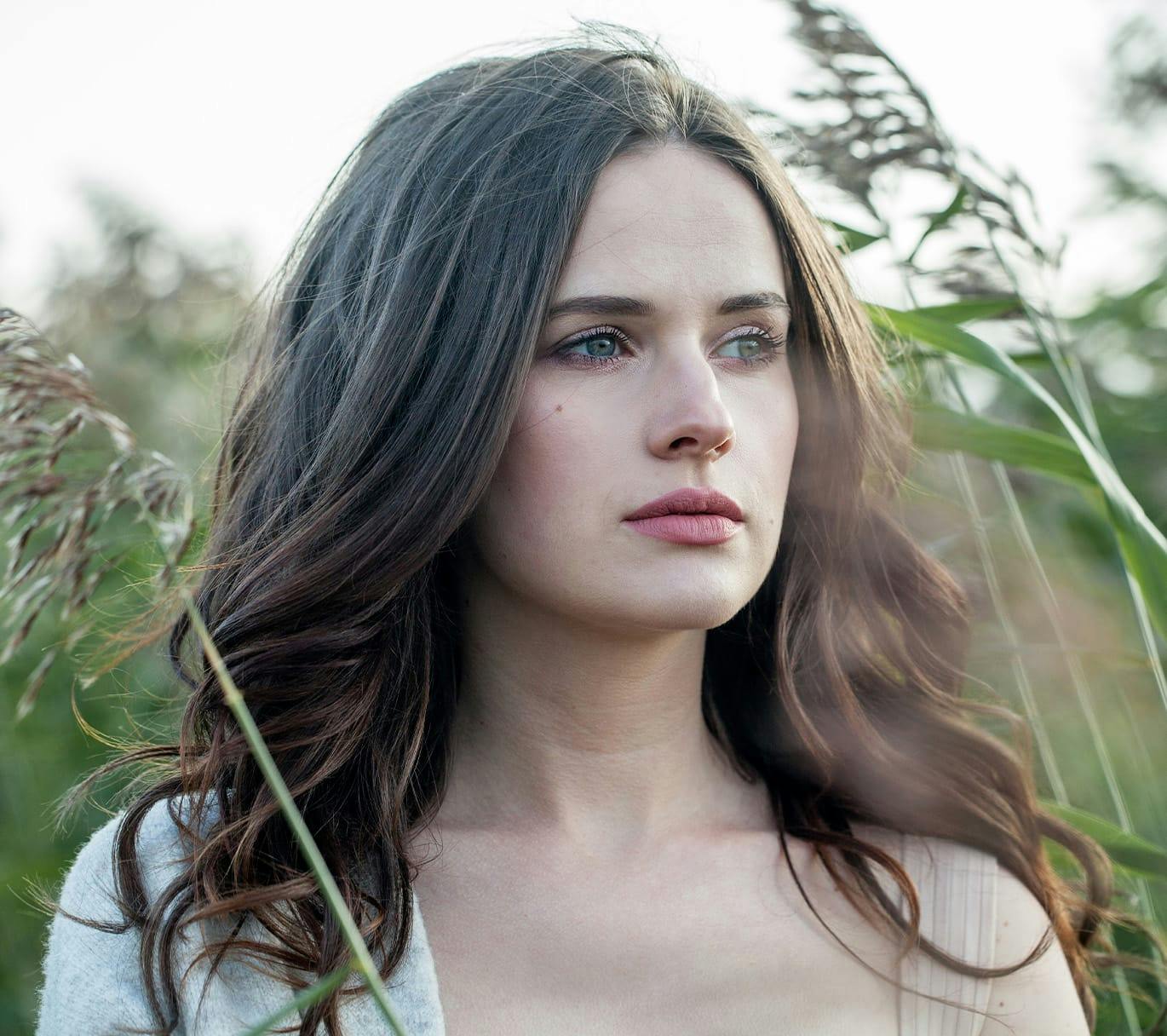 woman standing in tall grass
