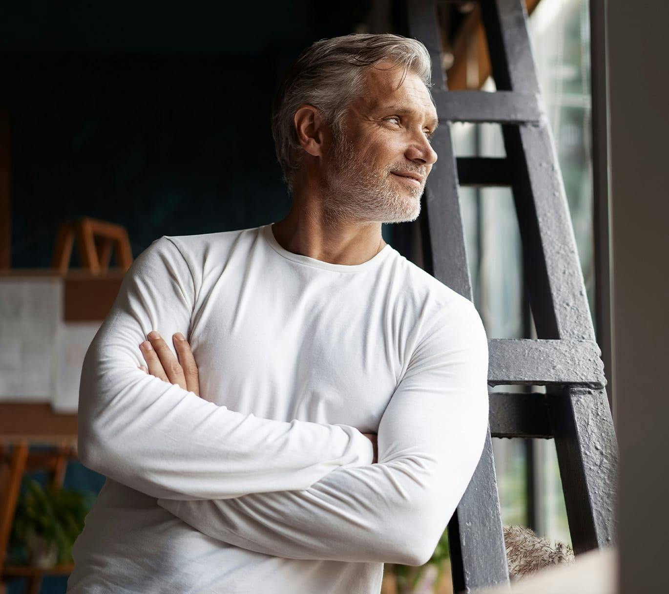 man looking out window