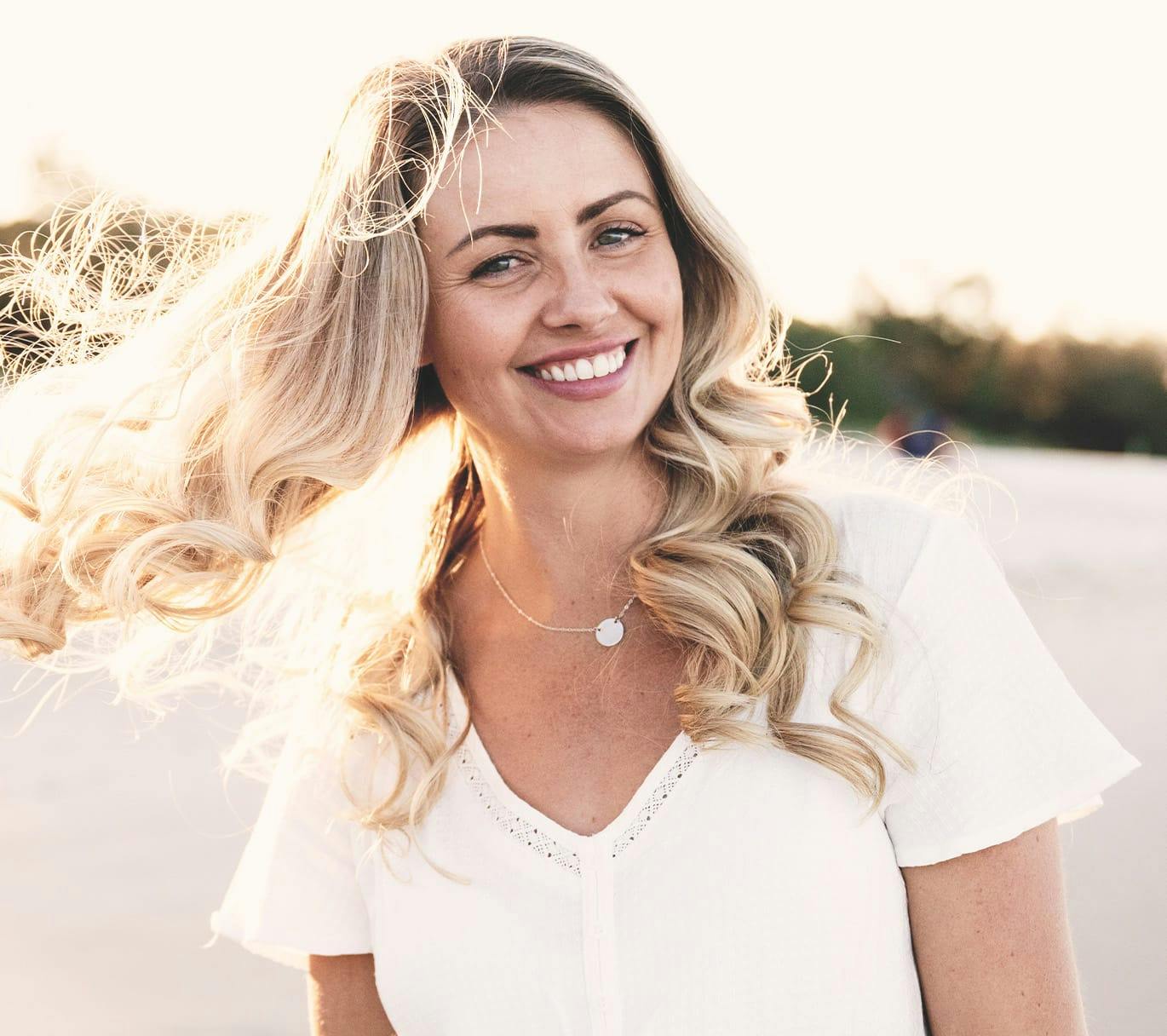 smiling woman twirling hair