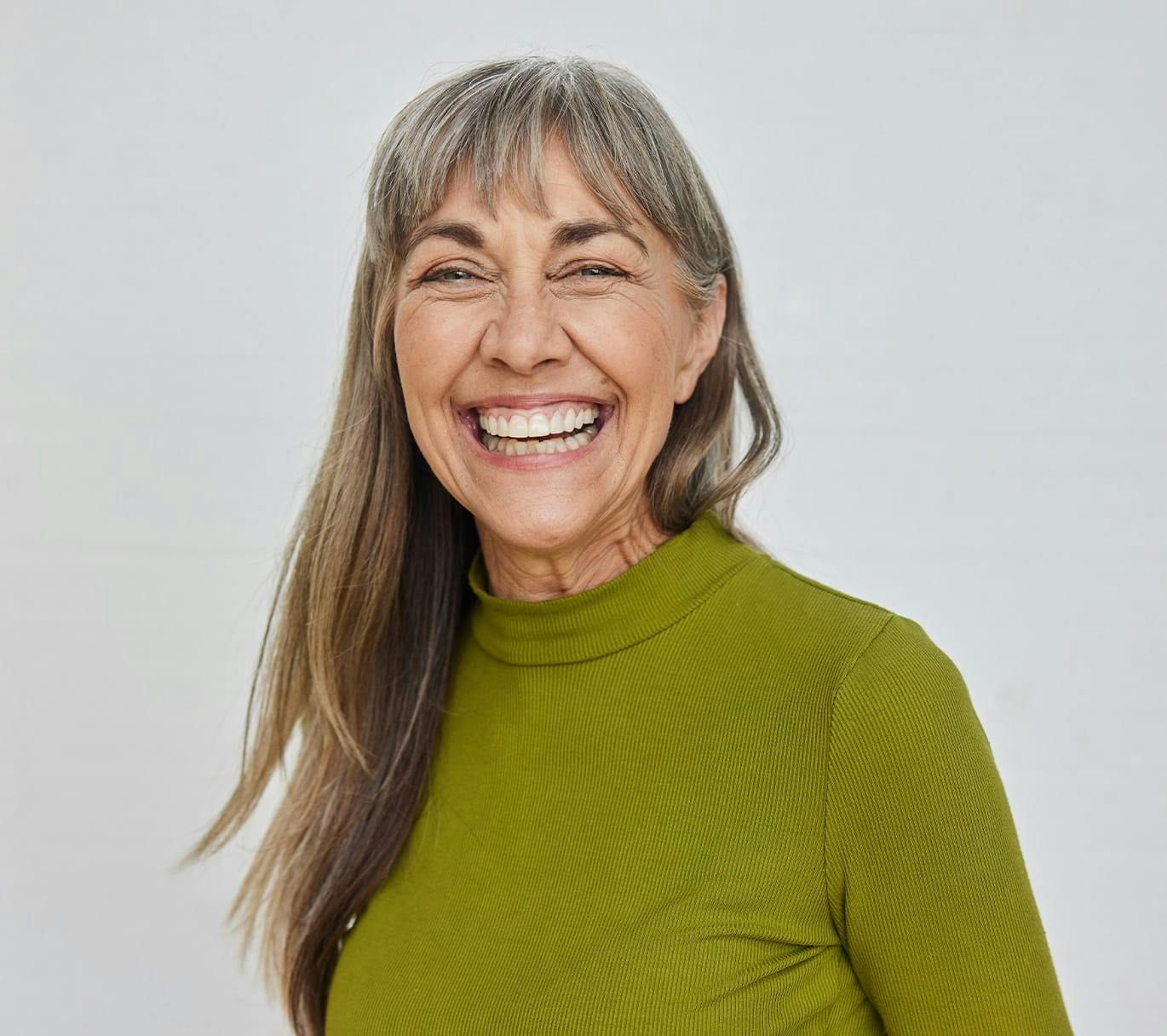 woman smiling in green sweater