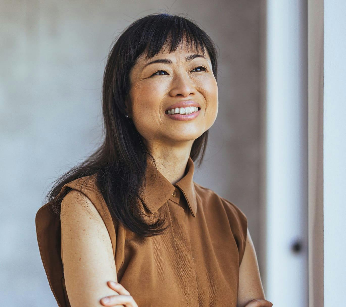 woman smiling with arms crossed