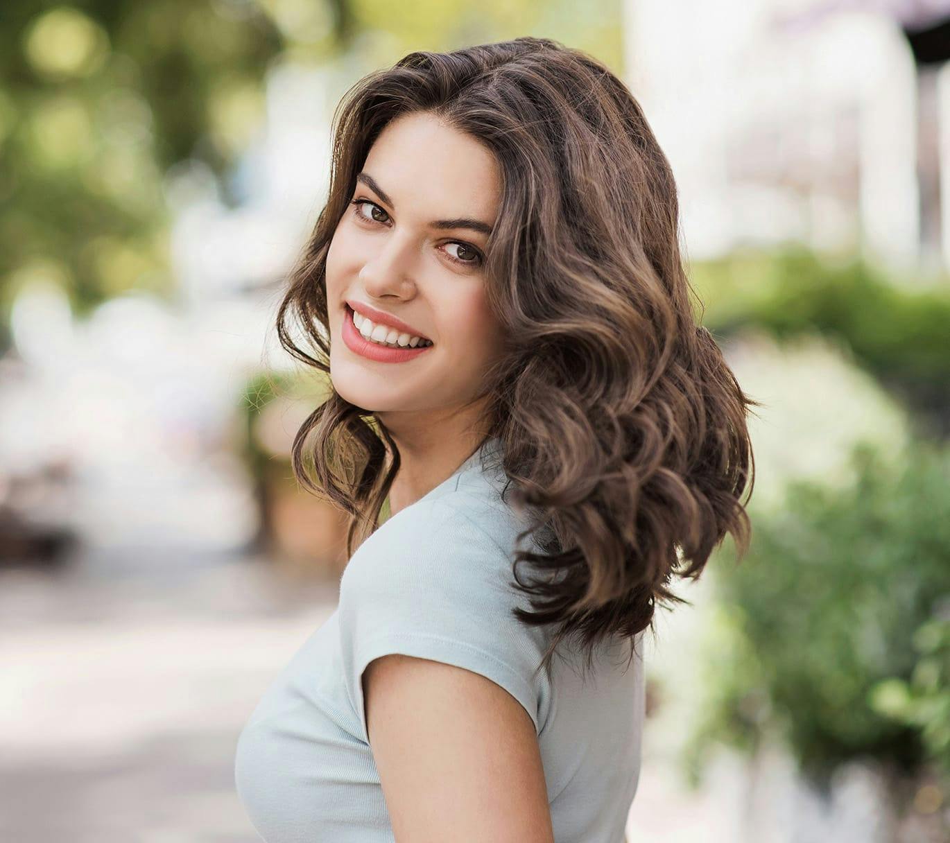 smiling woman turning her head back