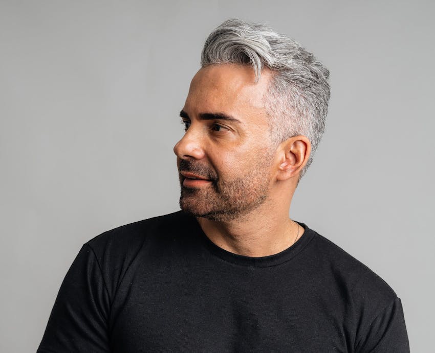 man with grey hair looks to the side
