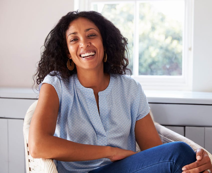 woman laughing in chair