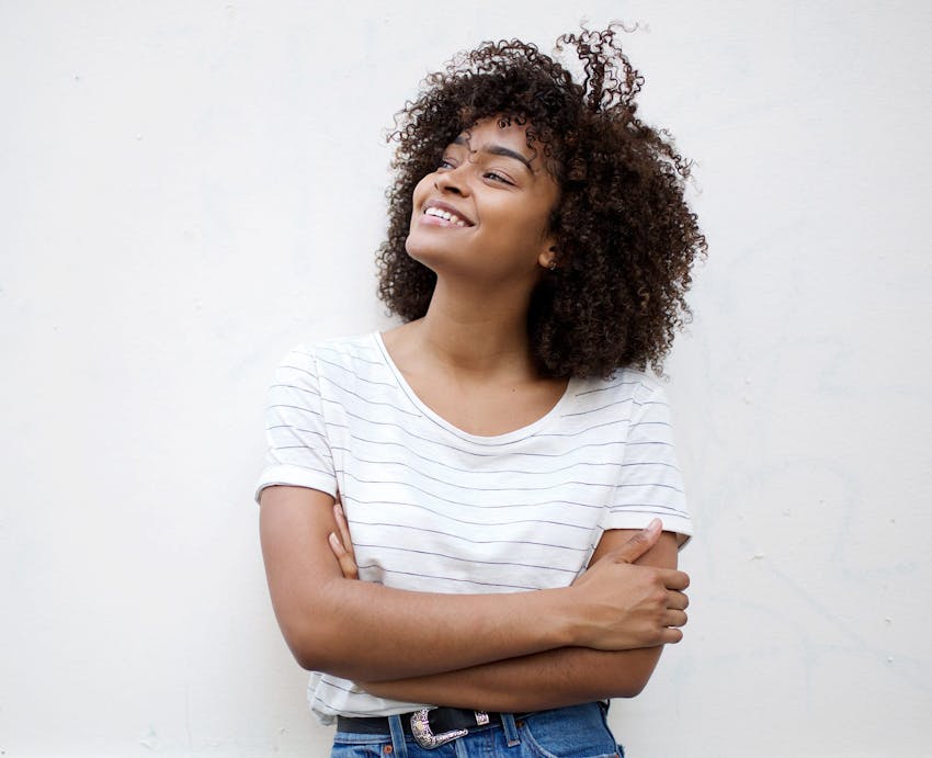 woman smiling with arms crossed