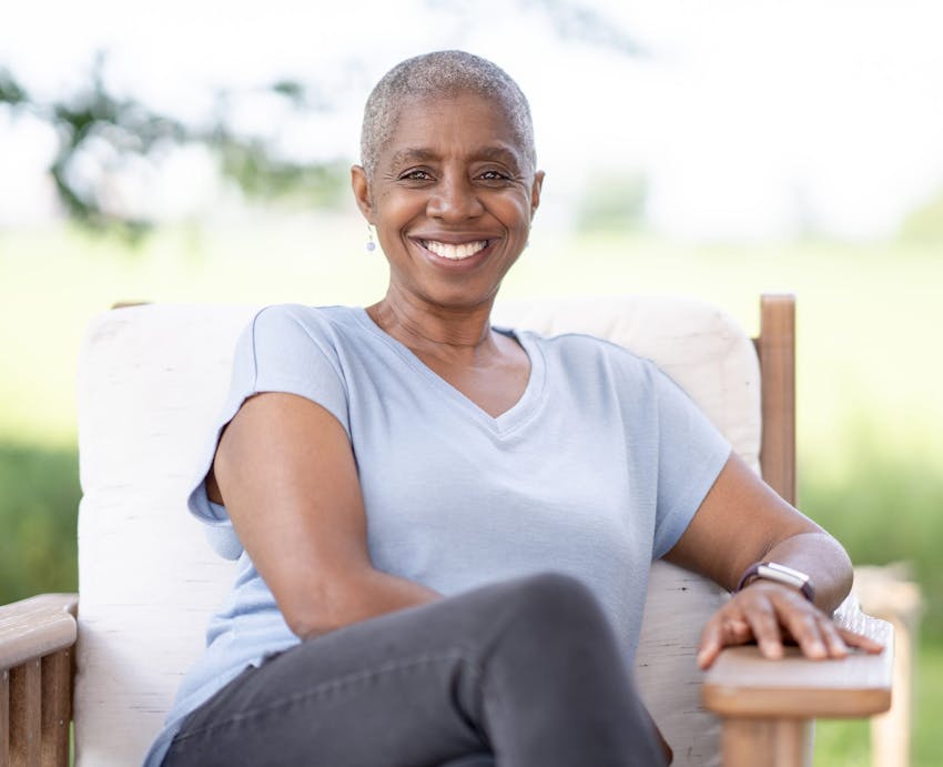 woman sitting in hair outside