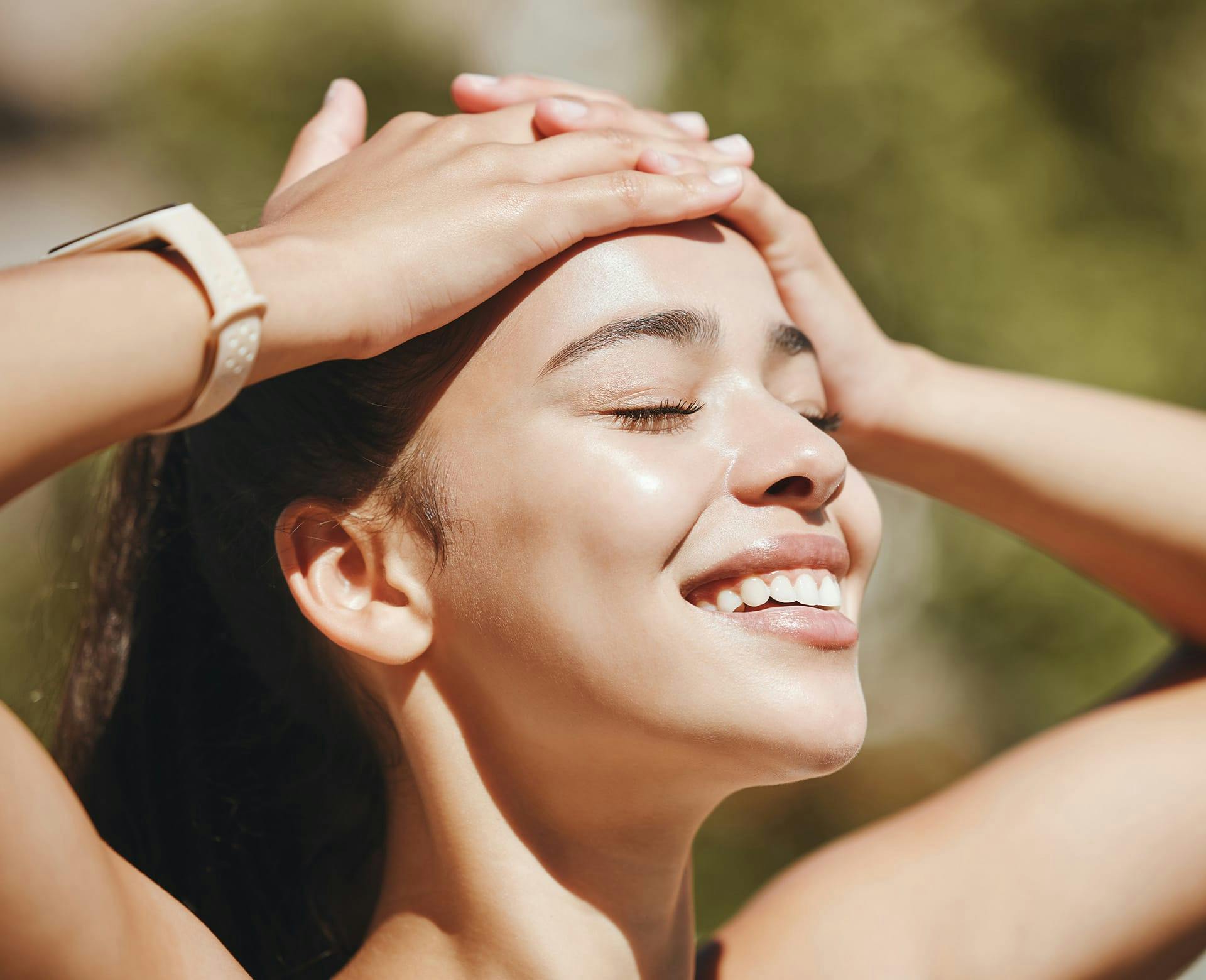 smiling woman with her eyes closed