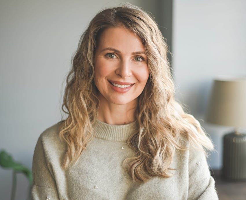 woman smiling in sweater