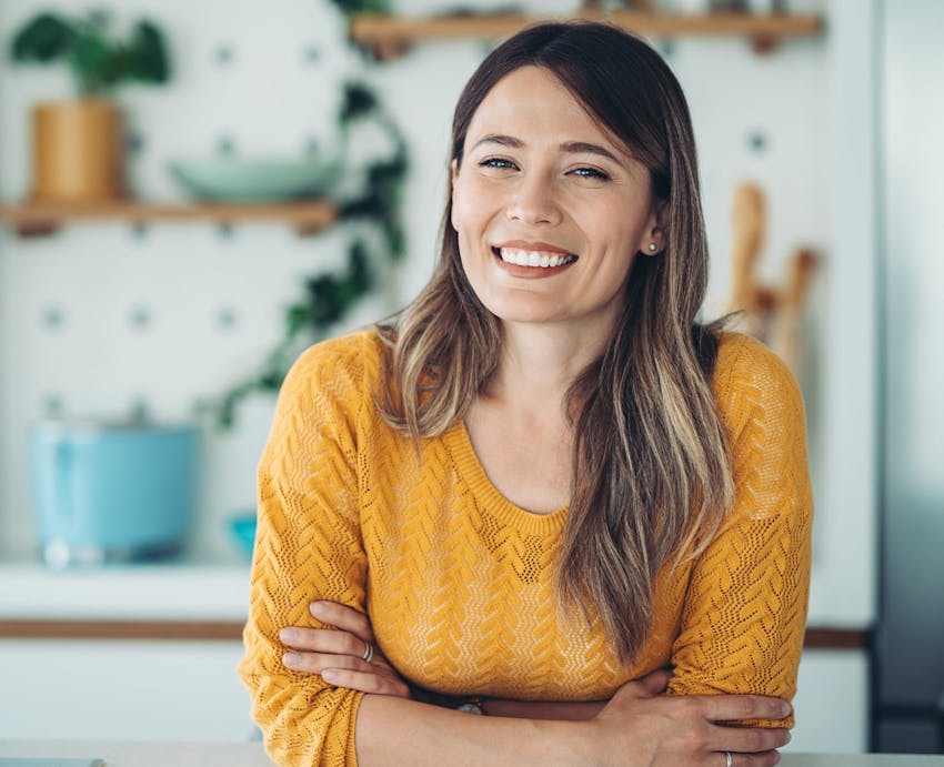 woman smiling with arms crossed