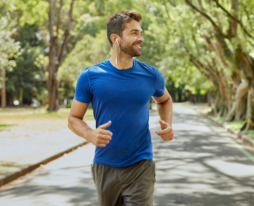 a man smiling and jogging