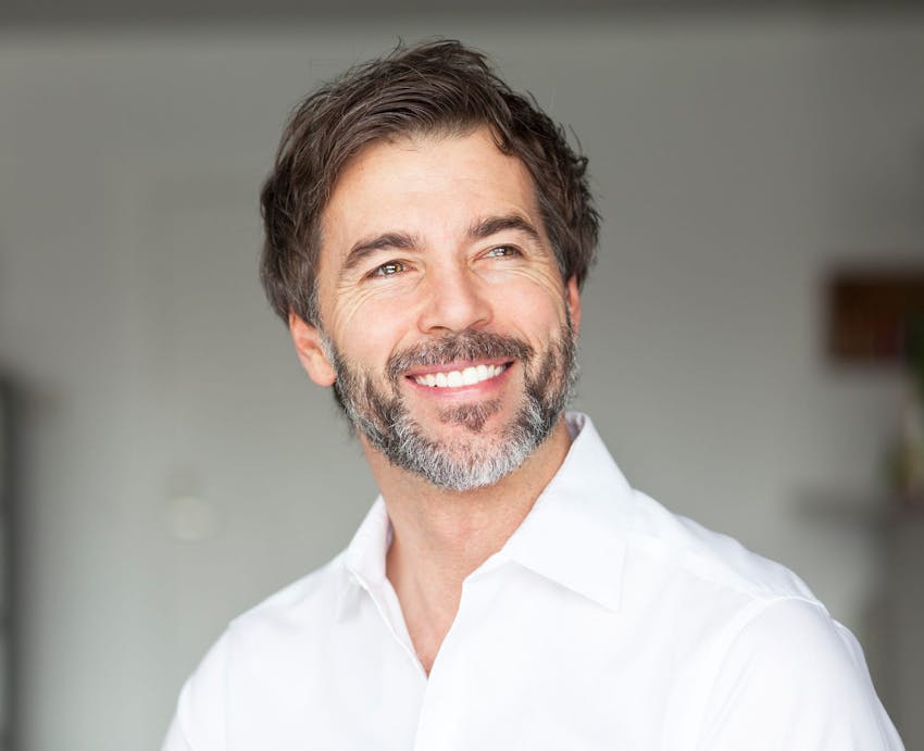 smiling man in white shirt