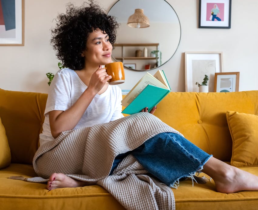 woman enjoying coffee on a couch