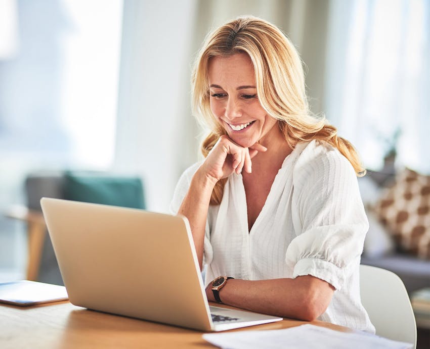 Woman smiling while working on a computer