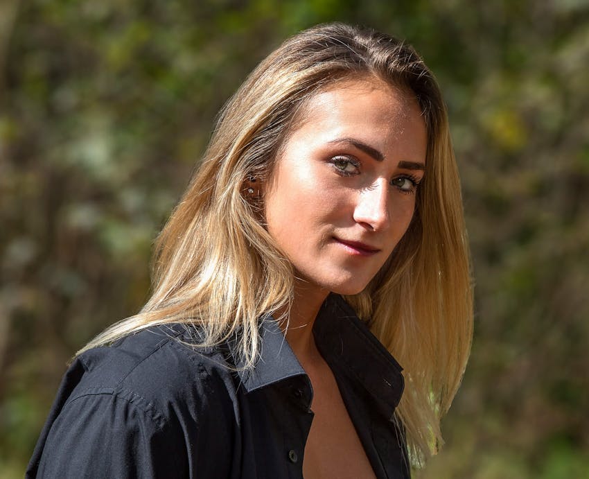 woman standing outside with black button up