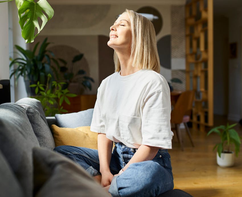 woman enjoying sunlight on couch