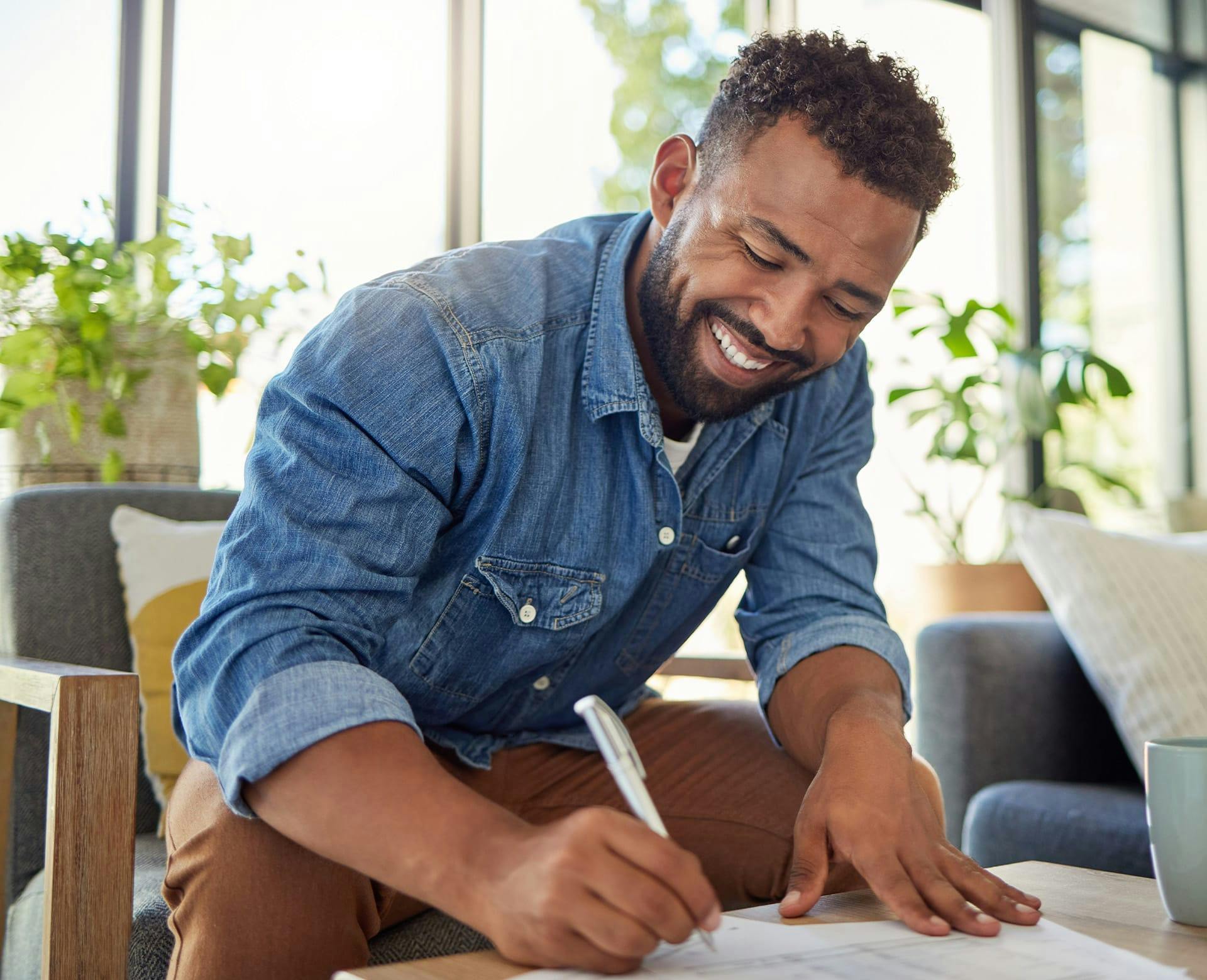 Man smiling filling out forms