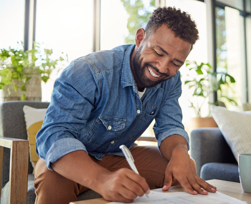 Man smiling filling out forms