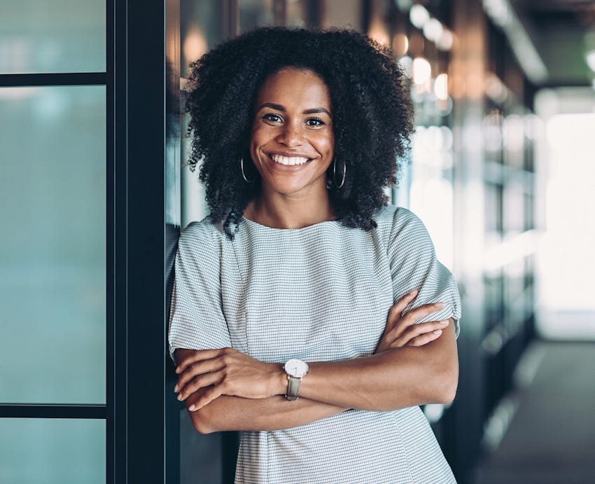 smiling woman leaning in doorway