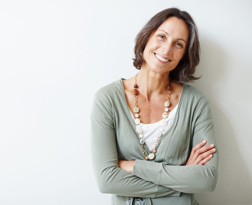 smiling woman with her arms crossed