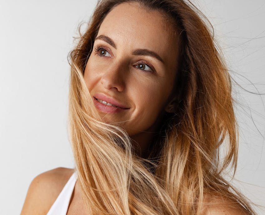 woman smiling with hair in face