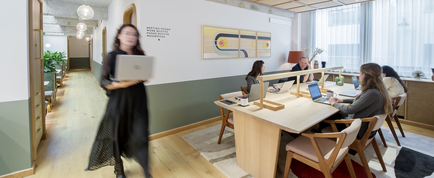 Lady with computer, table with people and computers