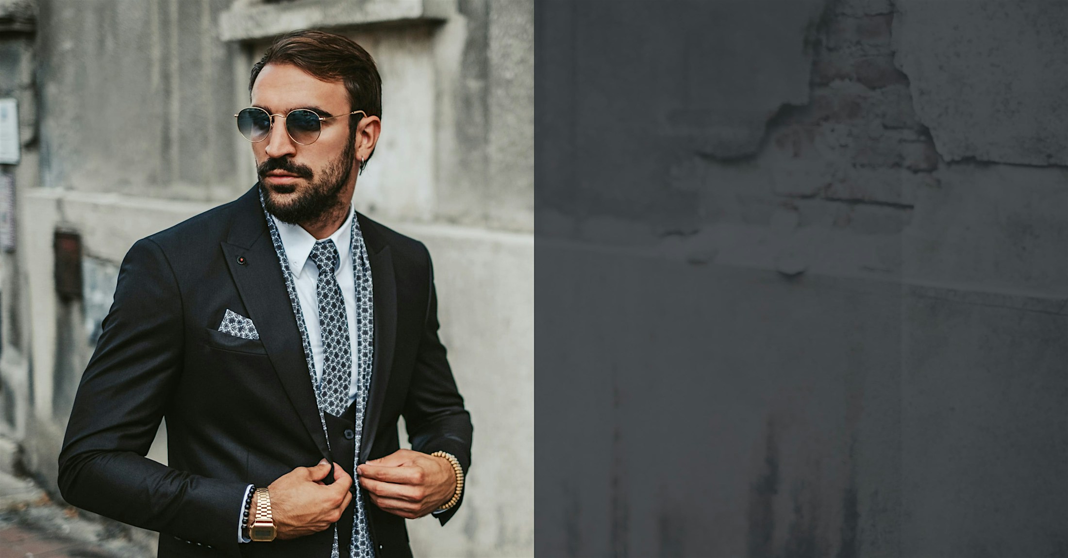 man in a suit and sunglasses walking outside