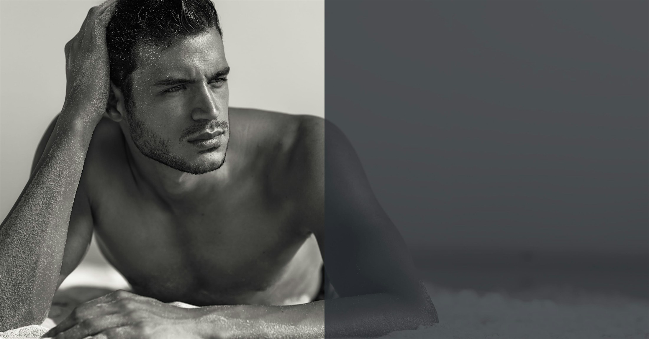 handsome man laying down at the beach