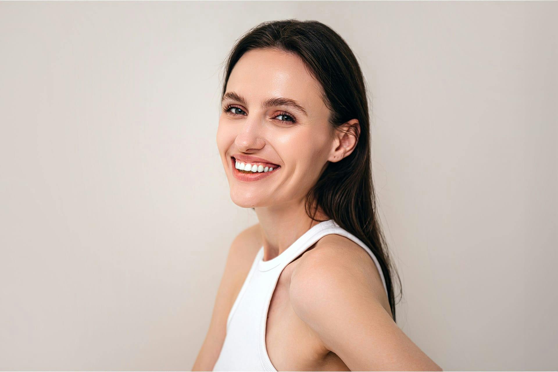 woman in a white tank top
