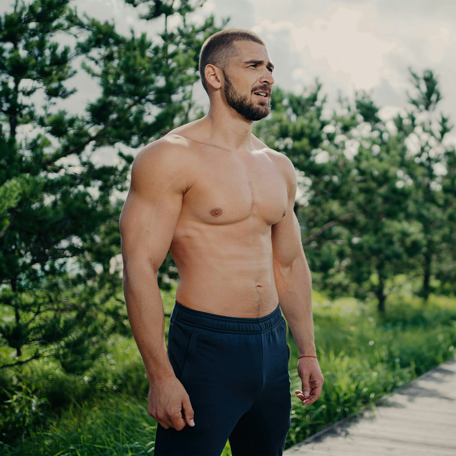 man outside wearing workout shorts and no shirt