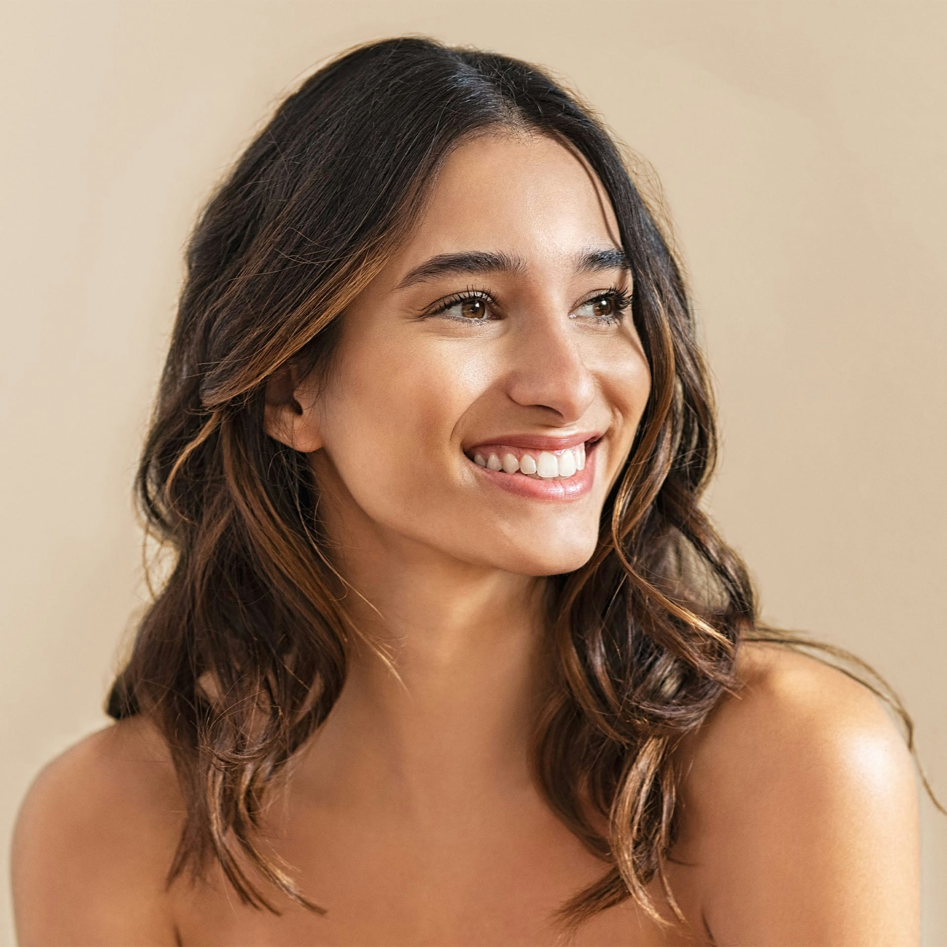 woman with brown curly hair smiling