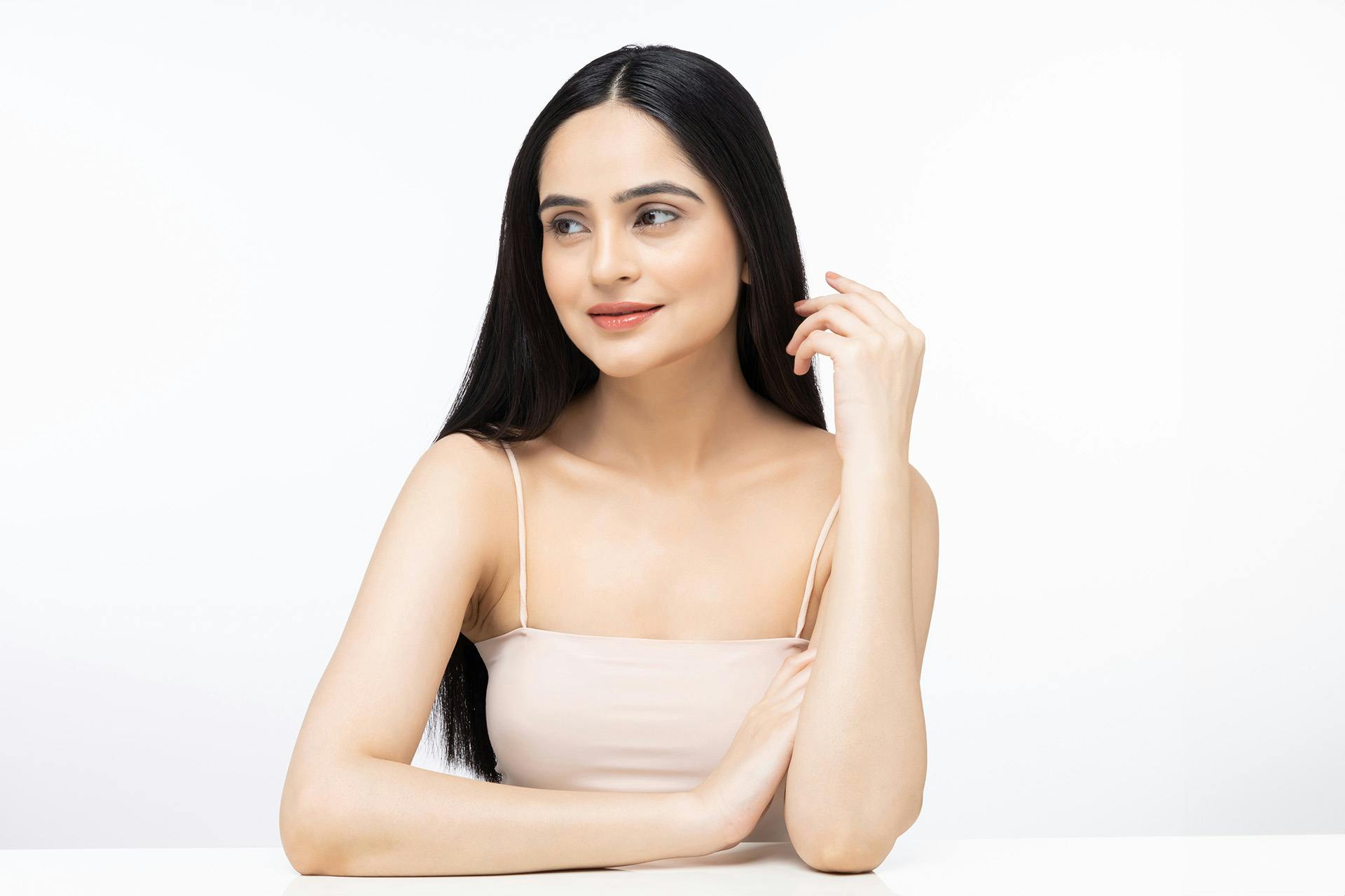 woman with long dark hair looking to the side