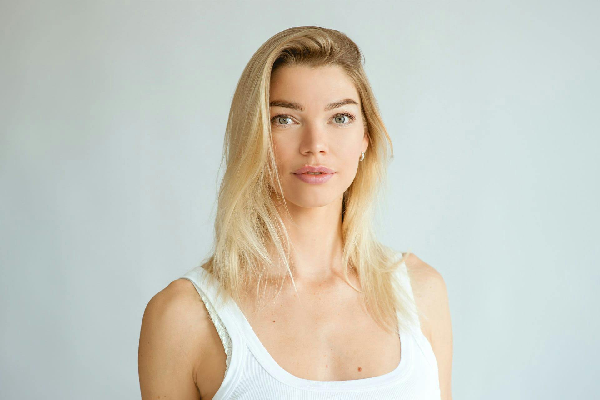 woman with blonde hair wearing a white shirt