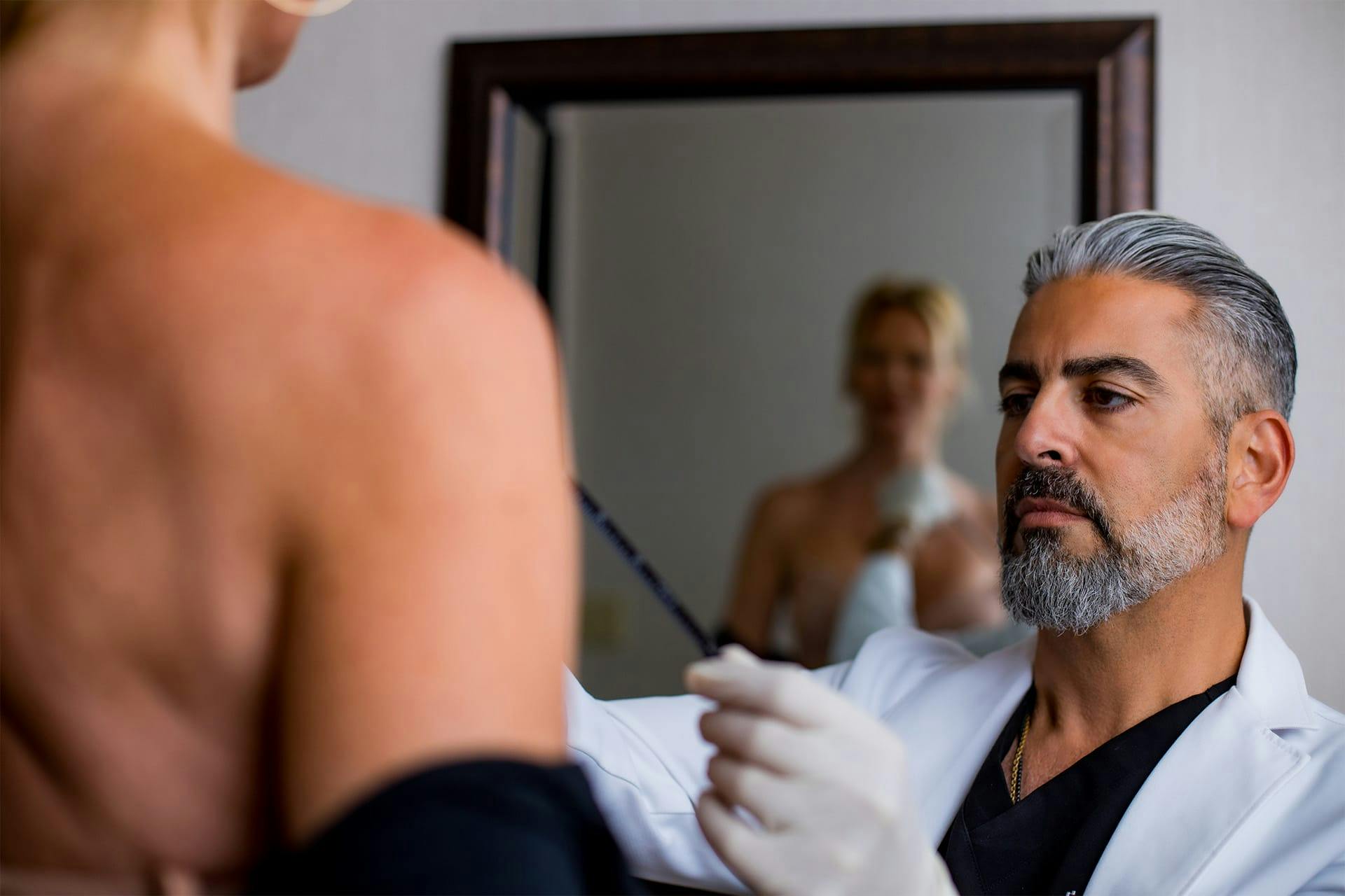 Dr. Firouz with a patient discussing breast surgery